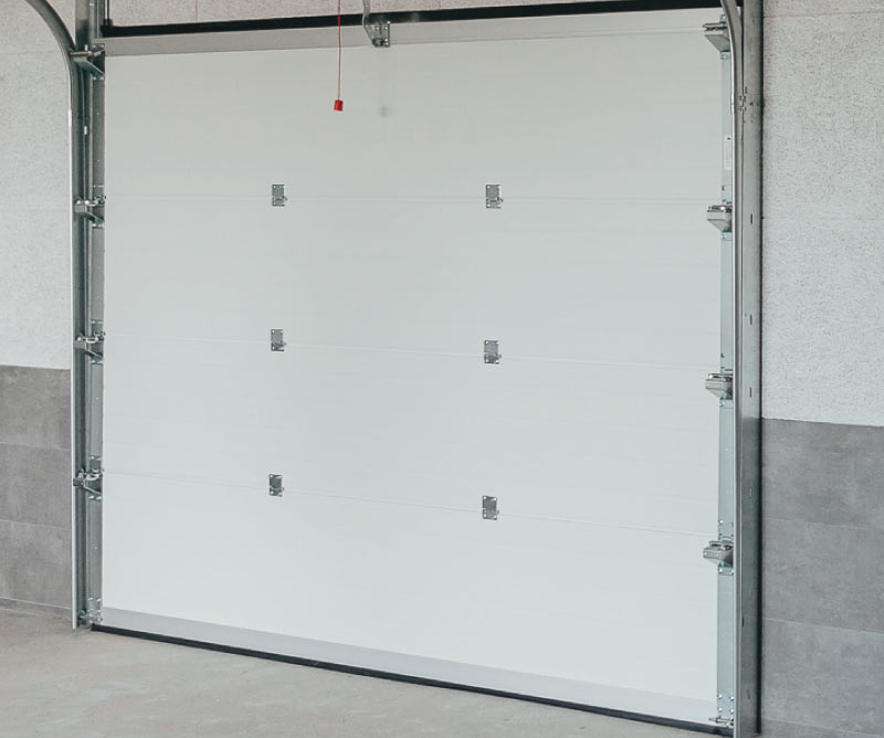 Bright interior behind a white sectional garage door